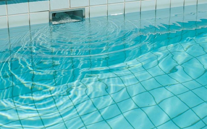 Return jet ripples on clear pool water showing circulation health check in Scottsdale, AZ