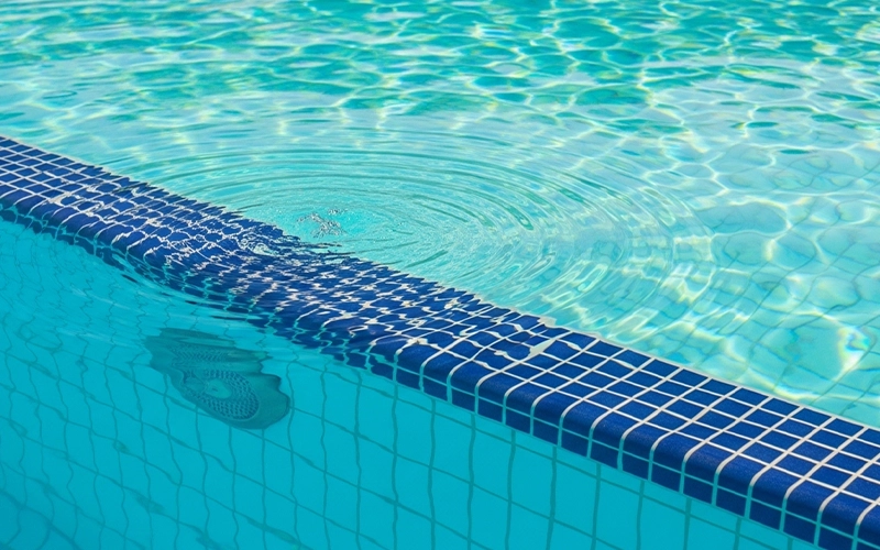 Return jet ripples on clear pool water showing steady circulation and smooth operation.