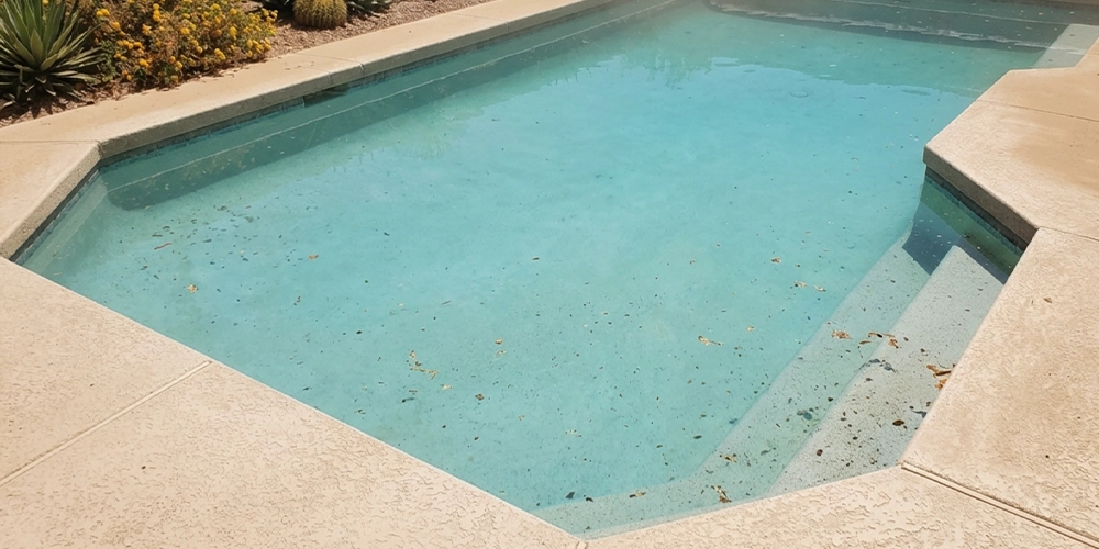 Arizona pool affected by sun, dust, and heat showing why weekly cleaning matters