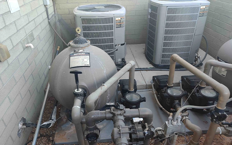 Hayward pool equipment pad with sand filter, pumps, and heaters installed for a residential swimming pool system.