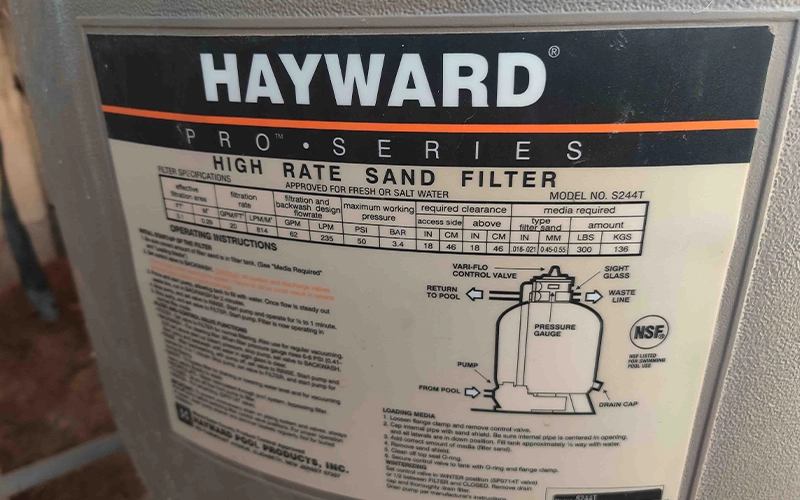 Close-up of the Hayward Pro Series high-rate sand filter specification label on residential pool equipment.