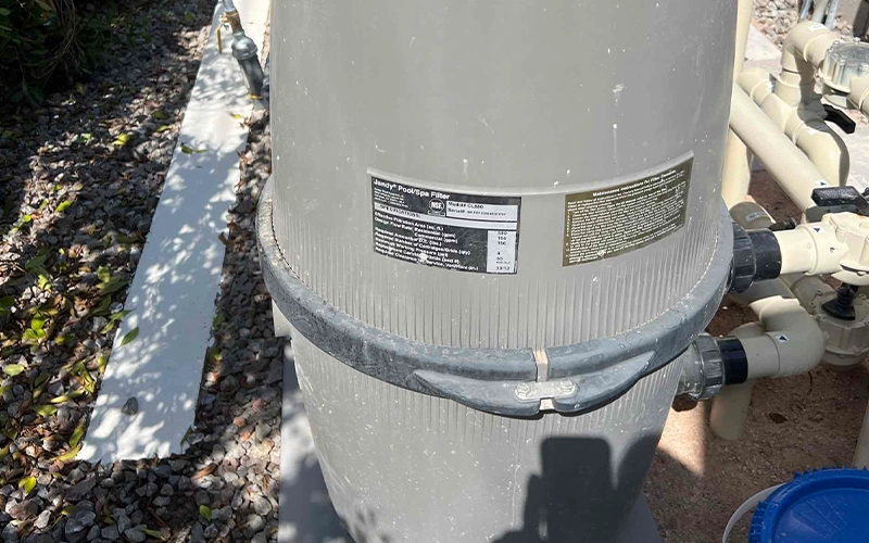 Jandy PoolSpa cartridge filter installed on a residential pool equipment pad with pressure gauge and PVC plumbing.