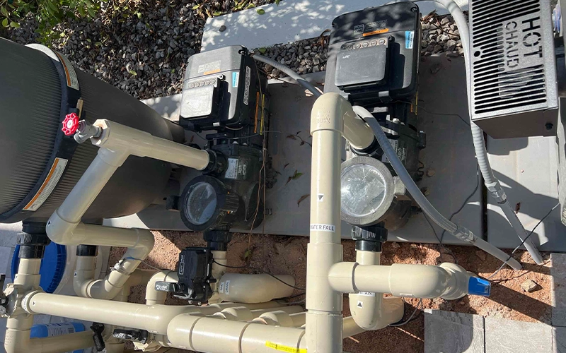 Jandy variable-speed pool pumps and cartridge filter installed on a residential pool equipment pad with automated plumbing controls.