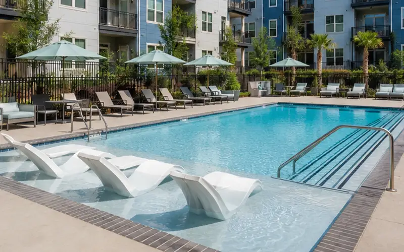 Apartment community pool with lounge area supported by commercial pool cleaning and repair services in Scottsdale and Mesa