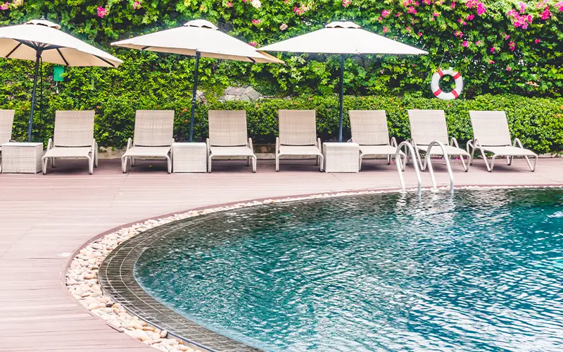 Commercial pool with lounge area maintained to reduce operational disruptions through reliable pool cleaning and maintenance services