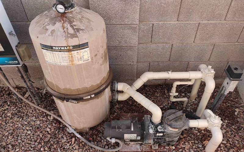 Hayward pool filter and pump system showing signs of wear before professional pool equipment inspection, repair, and maintenance.