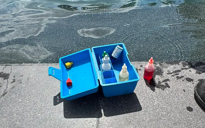 Pool technician testing water chemistry during green pool cleaning service in Scottsdale and Mesa Arizona