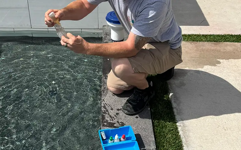 Pool technician testing water chemistry to improve water clarity and maintain balanced pool water
