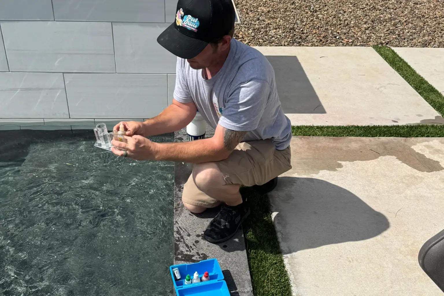Pool technician testing water chemistry for chemical balancing in Scottsdale and Mesa, AZ