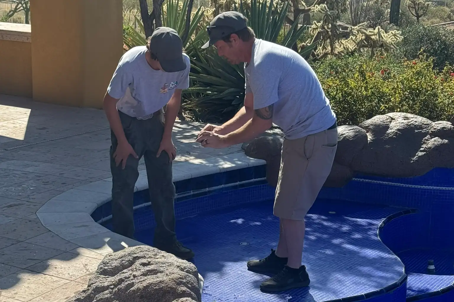 Pool inspection service in Scottsdale and Mesa Arizona with technicians checking pool condition and identifying potential maintenance issues