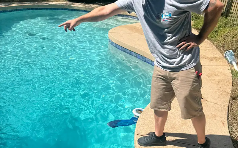 Professional pool technician inspecting and maintaining a residential swimming pool in Scottsdale and Mesa Arizona